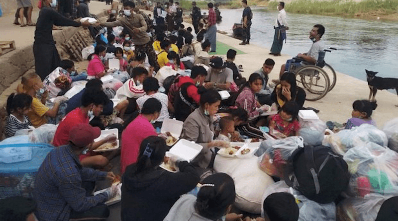 Karen refugees receive meals along the Moei River in Myanmar that serves as a border with Thailand as they prepare to return to their homes, Dec. 19, 2021. Photo Credit: Karen sources via BenarNews
