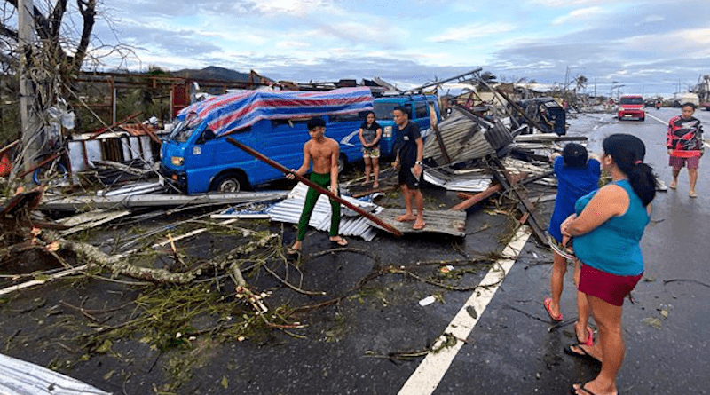 Residents in Surigao city, Philippines, clean up debris in the aftermath of Super Typhoon Rai (Odette), Dec. 18, 2021. Courtesy Erwin Mascarinas/Greenpeace