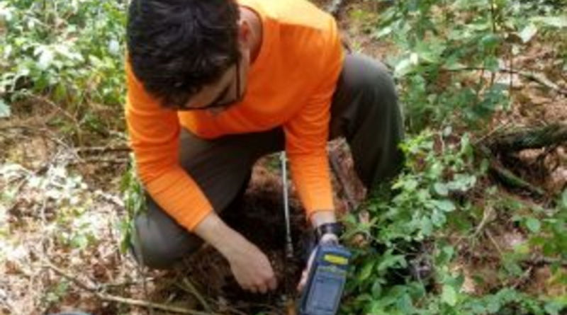 Researcher Mark Higgins testing soil with a probe that is used to collect soil samples at depth CREDIT: Mark Higgins