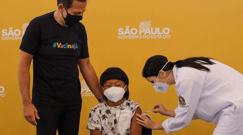 Davi, an eight-year-old from the Xavante indigenous people in Brazil, being vaccinated against COVID-19. Photo Credit: Sao Paulo government handout