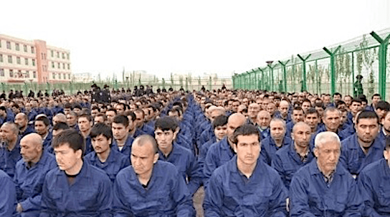 File photo of Uyghur detainees listening to speeches in a camp in Lop County, Xinjiang. Photo Credit: Wikipedia Commons
