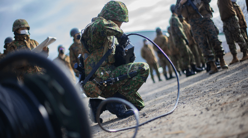 A Japanese soldier with the 4th Surface-to-Ship Missile Regiment, Japan Ground Self-Defense Force assembles a communication system as part of a launching unit fire mission drill during military exercise Resolute Dragon in Camp Hachinohe, Japan, Dec. 10, 2021. Photo Credit: Marine Corps Lance Cpl. Jonathan Willcox