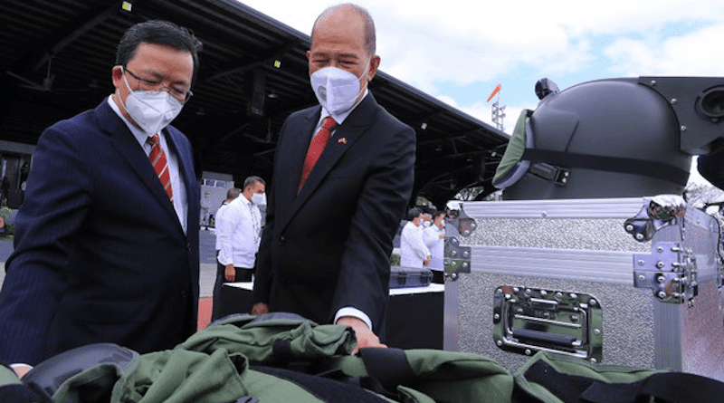 Chinese Ambassador Huang Xilian (left) and Philippine Defense Secretary Delfin Lorenzana inspect military equipment during a ceremonial handover at Camp Aguinaldo, Metro Manila, Feb. 9, 2022. Handout photo from Philippine Department of National Defense