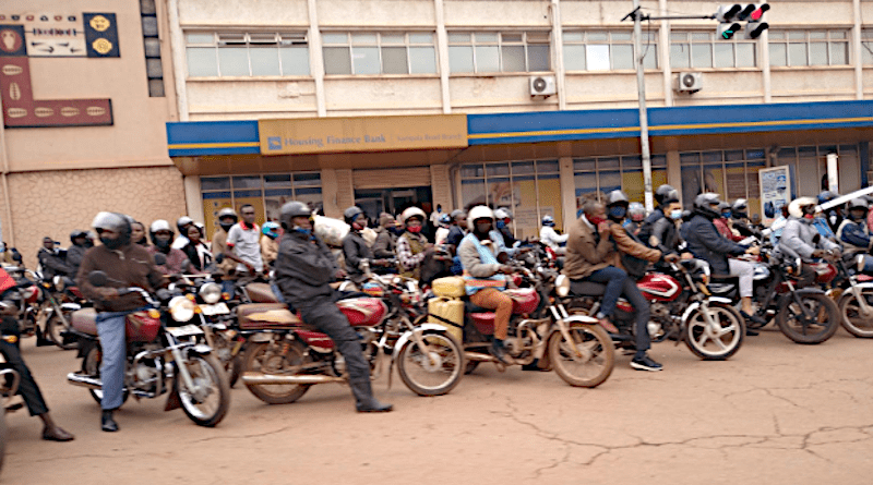 Motorcycle taxis, known as boda bodas, wait on the side of the road in Kampala, Uganda. Photo credit: Tom Courtright