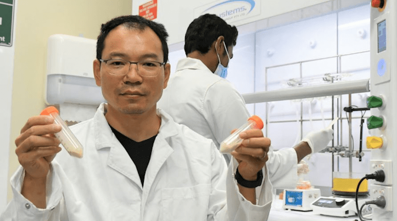Dr Zhongfan Jia holds the electroactive polymers used for organic batteries at his Flinders University laboratory in South Australia. CREDIT: Flinders University
