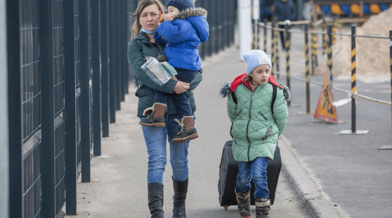 A woman who gave her name only as Iryna crosses the administrative border checkpoint at Stanytsya Luhanska with her son and daughter on February 20. Photo Credit: Marian Kushnir/RadioSvoboda.Org (RFE/RL)