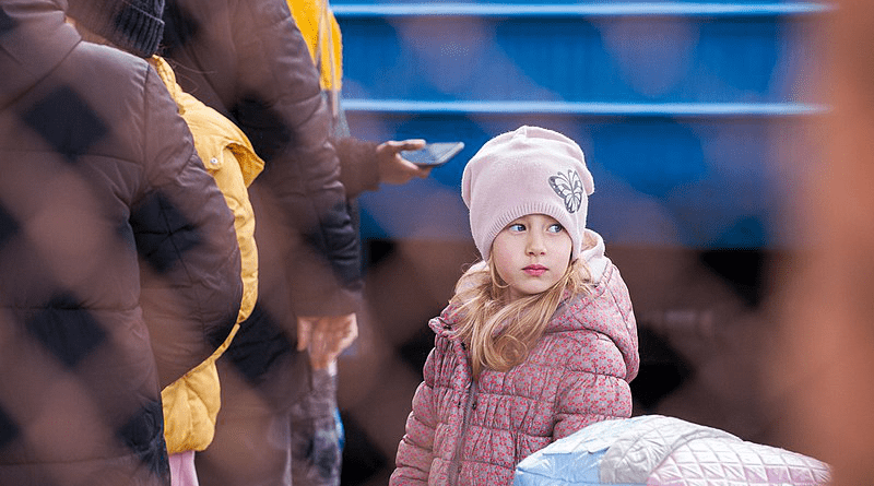 A young refugee from Ukraine in Przemyśl train station in Poland. Photo Credit: Mirek Pruchnicki, Wikipedia Commons