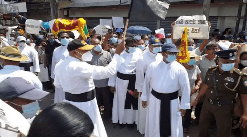 Protesters including priests and nuns march with posters and black flags calling on President Gotabaya Rajapaksa and his government to resign in Negombo on April 9. (Photo: UCA News)
