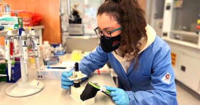 Emory University graduate student Selma Piranej, first author of the study, shown in the lab with a cell phone microscope set up to observe the rolling DNA-based motors. CREDIT: Salaita Lab, Emory University