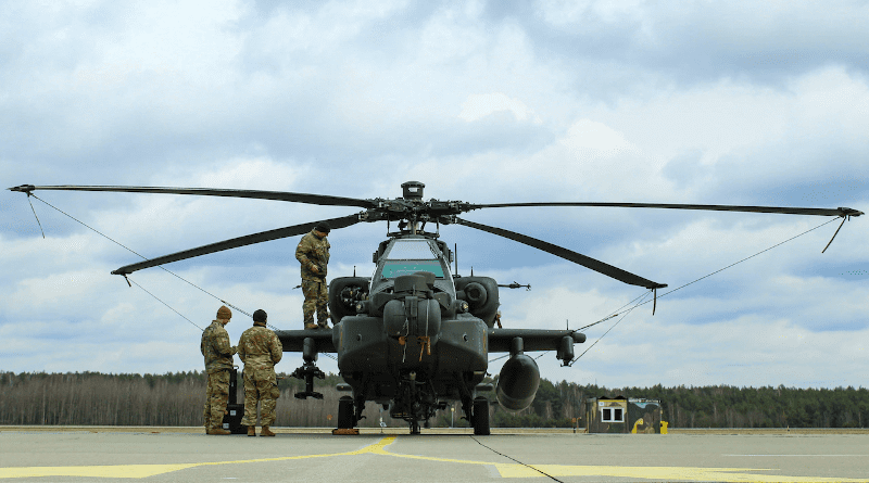 Soldiers assigned to 1st Air Cavalry Brigade, 1st Cavalry Division conduct daily preventive maintenance on an AH-64E Apache Guardian attack helicopter at a forward arming and refueling point, Miroslawiec, Poland, April 4, 2022. Photo Credit: Army Spc. Hedil Hernández, National Guard