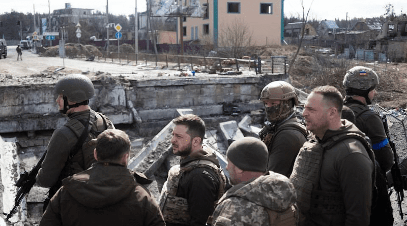 Ukraine's President Volodymyr Zelenskyy stands on a destroyed bridge in the town of Irpin. Photo Credit: Ukraine Defense Ministry