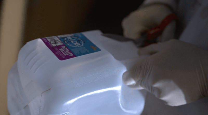 A plastic jug is fodder for a material developed at Rice University that turns waste plastic into a material that absorbs carbon dioxide. The lab is targeting flue gases that now require a far more complex process to sequester carbon dioxide. CREDIT: Jeff Fitlow/Rice University