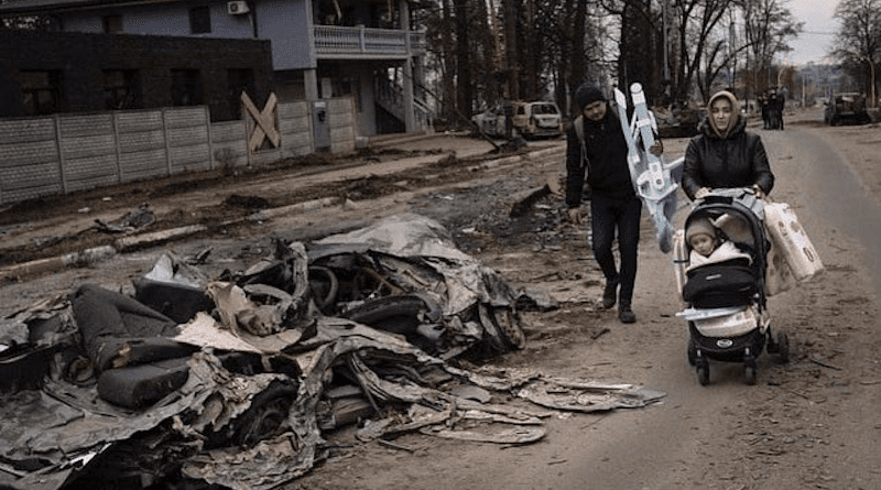 Ukrainian family flees in aftermath of Russia bombing. Photo Credit: Ukraine Ministry of Defense