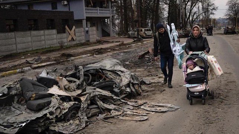 Ukrainian family flees in aftermath of Russia bombing. Photo Credit: Ukraine Ministry of Defense