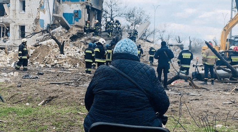 A woman waits for her family to be unearthed from under the rubble in Borodyanka after Russia attacks. Photo Credit: Ukraine Ministry of Defense.