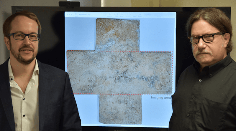 Georgia Tech professor David Citrin (right) and adjunct professor Alexandre Locquet stand in front of an image of the 16th-century funerary cross used in their study. CREDIT: Georgia Tech-Lorraine