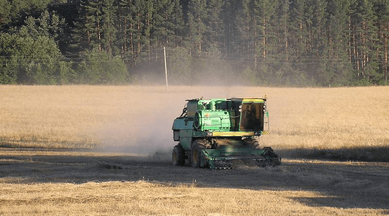 A harvester leaves a field in Russia wheat agriculture farm