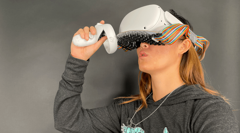 Vivian Shen, a Ph.D. student in Carnegie Mellon University's Robotics Institute, uses a virtual reality headset equipped with a phased array of ultrasound transducers to simulate the feeling of drinking on her lips. CREDIT: Carnegie Mellon University