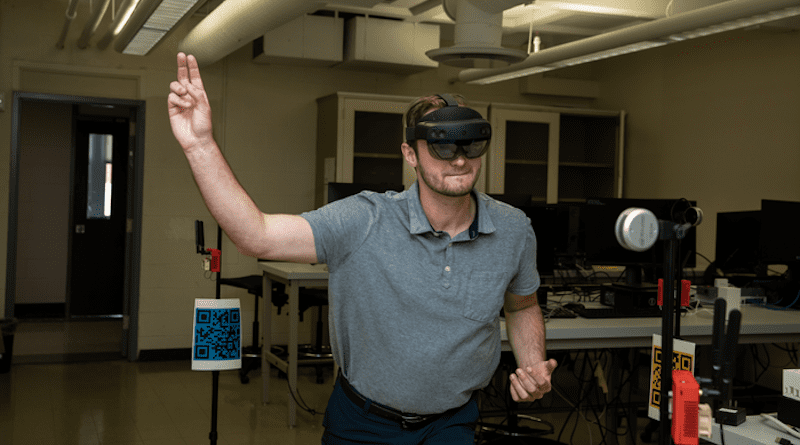 Tyler Stafflinger throws a virtual pitch while wearing an augmented reality headset CREDIT: NJIT