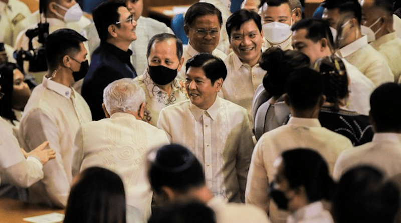 Members of Congress surround President Ferdinand Marcos Jr. moments before his first State of the Nation address at the House of Representatives in Quezon City, Metro Manila, July 25, 2022. FOCAP Pool/Xinhua/BenarNews