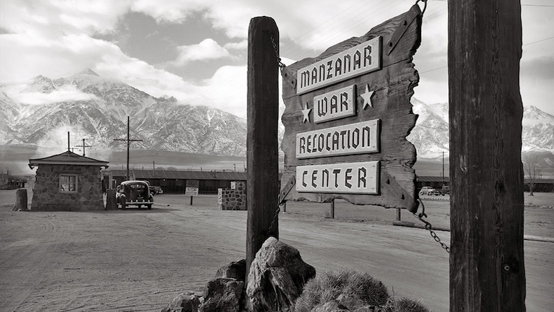 Wooden sign at entrance to the Manzanar War Relocation Center. Photo Credit: Ansel Adams, Wikipedia Commons