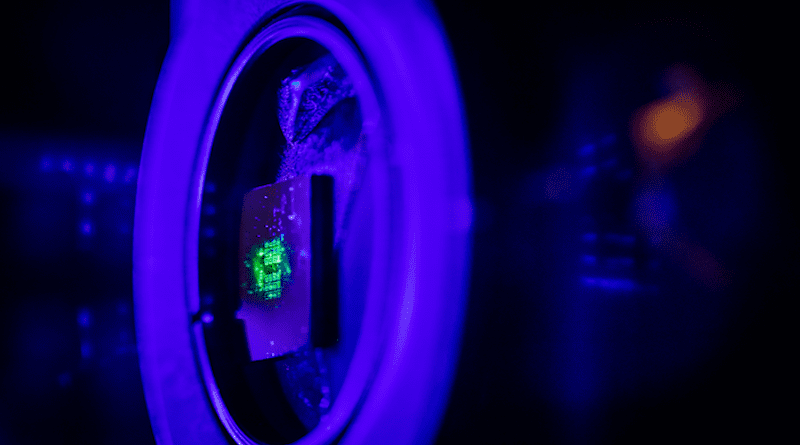 Green laser light illuminates a metasurface that is a hundred times thinner than paper, that was fabricated at the Center for Integrated Nanotechnologies. CINT is jointly operated by Sandia and Los Alamos national laboratories for the Department of Energy Office of Science. CREDIT: Craig Fritz, Sandia National Laboratories