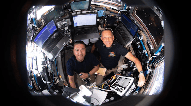 NASA astronauts (from left) Kjell Lindgren and Bob Hines are pictured inside the International Space Station's seven-windowed cupola monitoring the approach and rendezvous of Boeing's CST-100 Starliner spacecraft on the company's Orbital Flight Test-2 mission. Credits: NASA