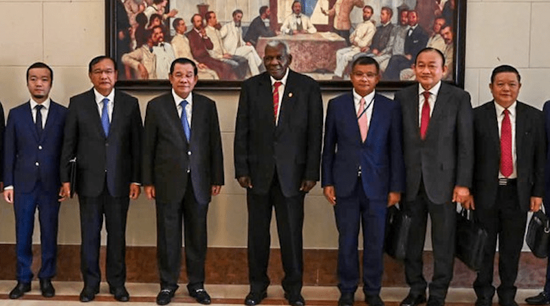 This Sept. 24 photo shows businessman Chen Zhi (far left) with Cambodian Prime Minister Hun Sen (third from left) and Cuban National Assembly President Esteban Lazo Hernández (fourth from left). Also pictured, from left to right, are Cambodian Foreign Affairs Minister Prak Sokhonn, Health Minister Mam Bunheng, Deputy Prime Minister Sry Thamarong and Minister Kao Kim Hourn. Credit: Hun Sen/Facebook