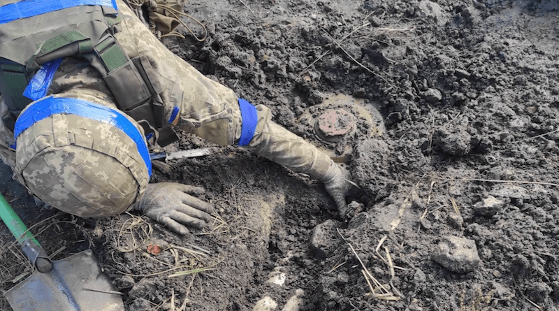 Ukrainian soldier removes Russian landmine. Photo Credit: Ukraine Defense Ministry