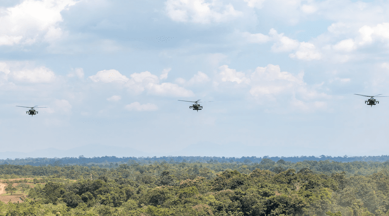 A U.S. Army AH-64E Apache helicopter assigned to 1-229 Attack Battalion, 16th Combat Aviation Brigade is flanked by two Indonesian army AH-64E Apache helicopters during a combined arms live-fire rehearsal for Exercise Super Garuda Shield 22 near Baturaja, Indonesia, Aug. 11, 2022. Photo Credit: Army Capt. Kyle Abraham