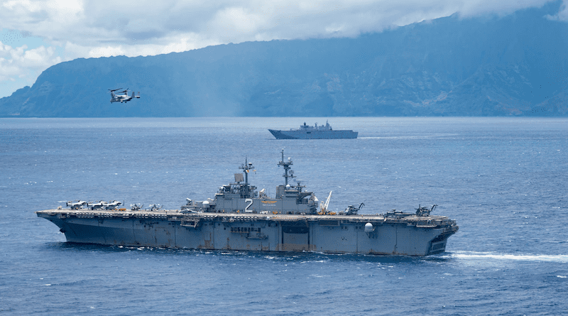 The U.S. Navy’s USS Essex, front, and the Australian navy’s HMAS Canberra sail on the Pacific Ocean during Rim of the Pacific 2022 on the Hawaiian coast. Photo Credit: Navy Petty Officer 2nd Class Wesley Richardson