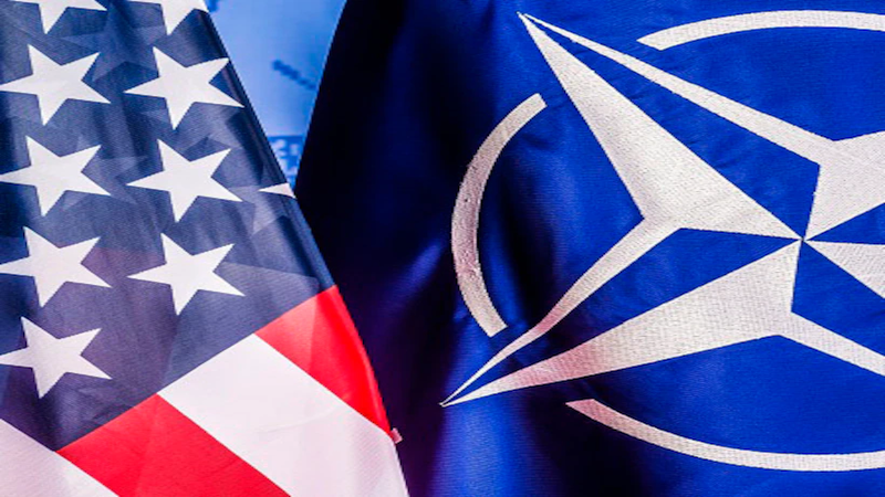 Flags of the United States and NATO. Photo Credit: DOD