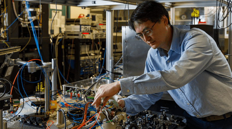 Sandia National Laboratories atomic physicist Jongmin Lee examines the sensor head of a cold-atom interferometer that could help vehicles stay on course where GPS is unavailable. CREDIT: Bret Latter, Sandia National Laboratories