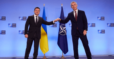 Ukrainian President Volodymyr Zelensky (left) and NATO Secretary-General Jens Stoltenberg bump fists at a press conference in Brussels in December 2021. Photo Credit: Ukraine Government, RFE/RL