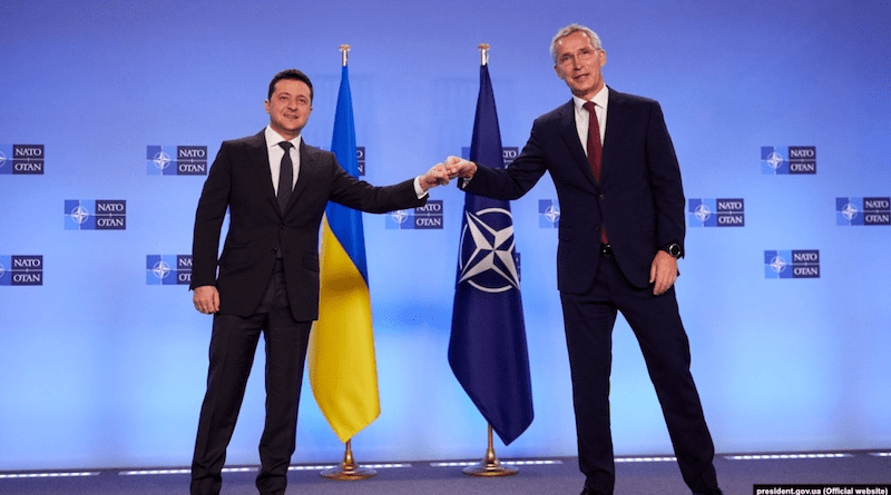 Ukrainian President Volodymyr Zelensky (left) and NATO Secretary-General Jens Stoltenberg bump fists at a press conference in Brussels in December 2021. Photo Credit: Ukraine Government, RFE/RL