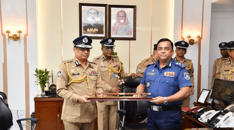 Chowdhury Abdullah Al-Mamun (left), Bangladesh’s new Inspector General of Police, receives the ceremonial baton from predecessor Benazir Ahmed at police headquarters in Dhaka, Sept. 30, 2022. Courtesy Police Headquarters Bangladesh