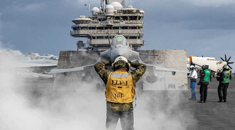 A sailor assigned to the aircraft carrier USS George H.W. Bush, directs a French Rafale fighter jet onto the catapult during multi-carrier operations between the George H.W. Bush Carrier Strike Group, Charles de Gaulle CSG, and the Italian Cavour CSG in the Mediterranean Sea, Nov. 23, 2022. Photo Credit: Navy Petty Officer 3rd Class Samuel Wagner