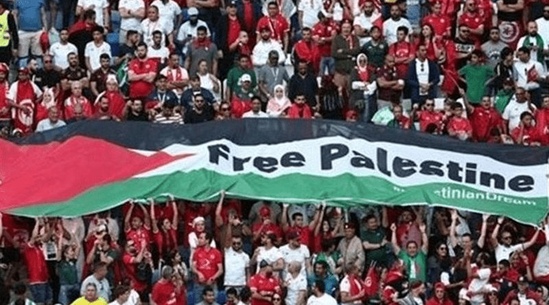 Tunisian fans fly the Palestinian flag during the game against Australia, Al-Janoub Stadium, Qatar. Photo Credit: Tasnim News Agency