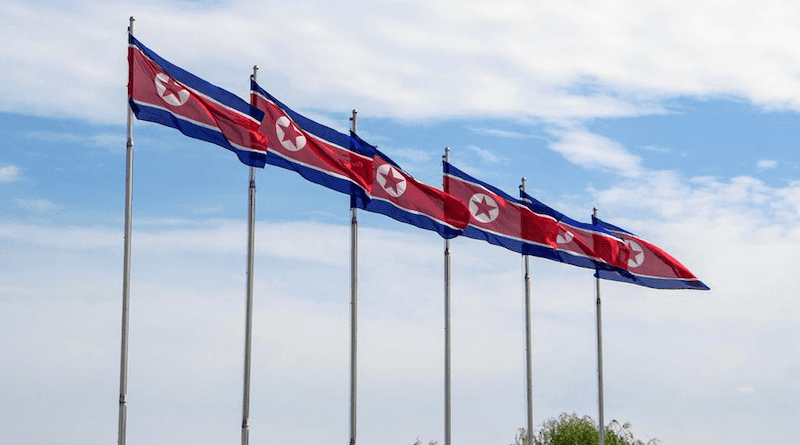Flags of the Democratic People's Republic of Korea fly in Pyongyang. Photo Credit: Unsplash/Micha Brändli