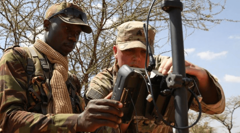 Army Sgt. Dominic McNally trains a member of the Kenya Defense Force on surveying equipment at the Archers Post Training Area in Larisoro, Kenya. Photo Credit: Army Sgt. Justin Martin
