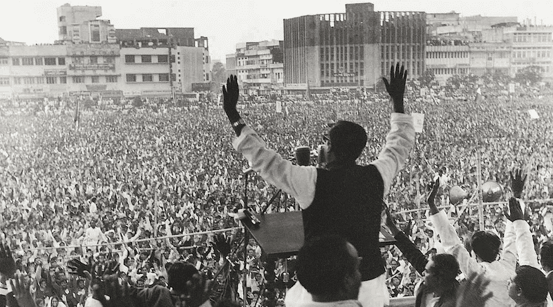 Sheikh Mujibur Rahman waving to crowds at a rally in Dhaka's Paltan Maidan. Photo Credit: Dawn/White Star Archives, Wikipedia Commons