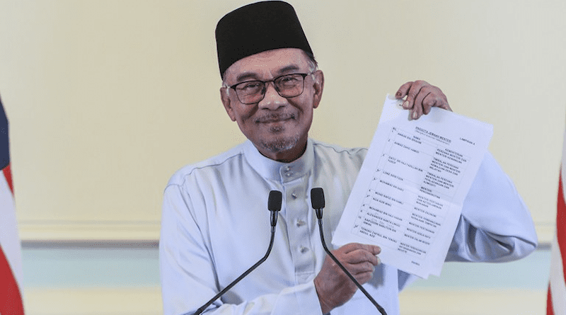 Malaysian Prime Minister Anwar Ibrahim holds up a list of his cabinet members during a press conference in Putrajaya, Malaysia, Dec. 2, 2022. [S. Mahfuz/BenarNews]