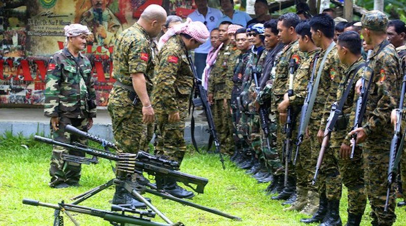 Moro National Liberation Front commander Nurudin Parnan (center), inspects weapons on display at one of the group’s camps in Maguindanao province, southern Philippines, May 23, 2017. Photo Credit: Mark Navales/BenarNews