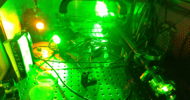 Shooting a green laser through a tube filled with a particular ionic liquid (right side of photo) can easily convert the green laser light to orange (upper left)—a long-sought color for medical applications. The method can be tailored for different color shifts by choosing different ionic liquids. CREDIT: Brookhaven National Laboratory