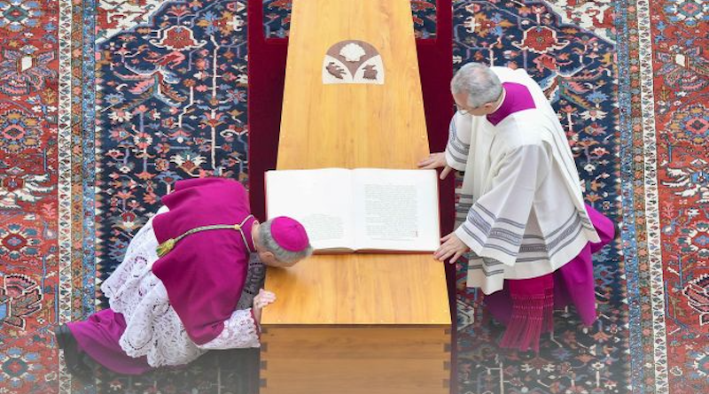 Archbishop Georg Ganswein (left), longtime personal secretary of Pope Benedict XVI, kisses the coffin of friend and mentor at his funeral on Jan. 5, 2023, at the Vatican. | Vatican Media
