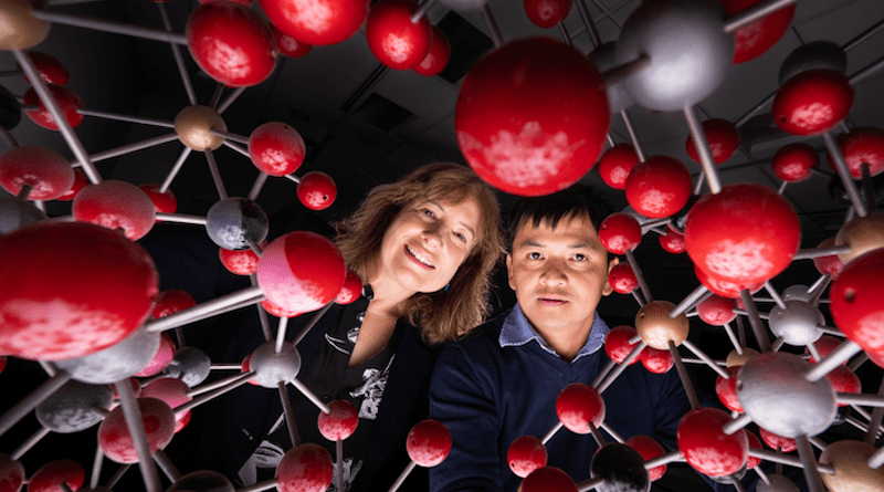 Sandia National Laboratories bioengineer Susan Rempe, left, and chemical engineer Tuan Ho peer through an artistic representation of the chemical structure of a kind of clay. Their team is studying how clay could be used to capture carbon dioxide. CREDIT: Photo by Craig Fritz/Sandia National Laboratories