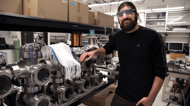 Brian Iezzi poses for a portrait with the photonic fibers fabric he developed. Photo by Marcin Szczepanski/Lead Multimedia Storyteller, University of Michigan College of Engineering
