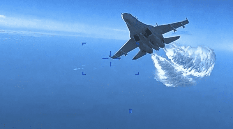 A Russian Su-27 approaching the back of the MQ-9 drone and beginning to release fuel as it passes, over the Black Sea. Photo Credit: Screenshot of US Air Force video