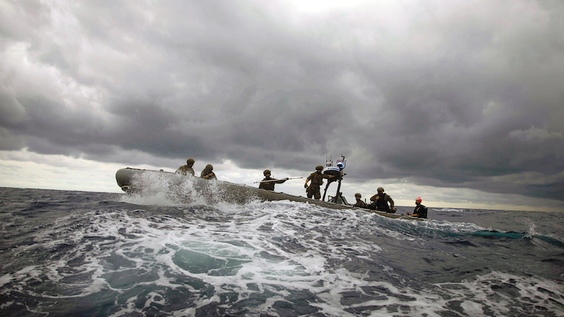 Coast Guardsmen assigned to Tactical Law Enforcement Team 109, Cape Cod Maritime Safety Security Team, and Sailors assigned to USS Sioux City, participate in noncompliant vessel pursuit tactics exercise in rigid-hull inflatable boat, Atlantic Ocean, April 1, 2021 (U.S. Navy/Marianne Guemo)