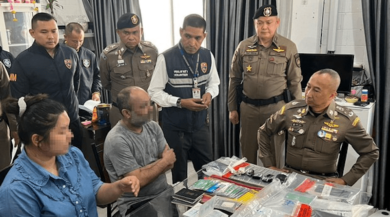 Deputy national police chief Gen. Torsak Sukvimol (seated right) interrogates a prime suspect (seated second from left) in a call center scam ring, in Bangkok, March 21, 2023. [Thai Police handout]